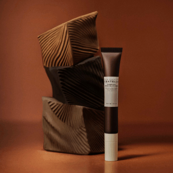 Close-up of SKIN1004 Probio‑Cica Bakuchiol Eye Cream tube and silicon applicator