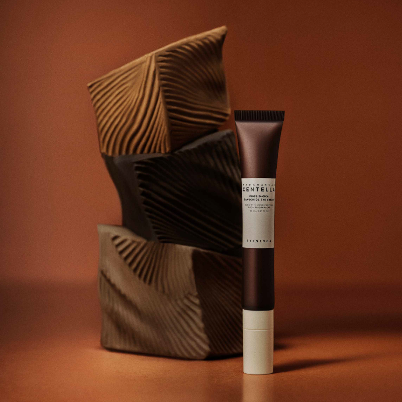 Close-up of SKIN1004 Probio‑Cica Bakuchiol Eye Cream tube and silicon applicator